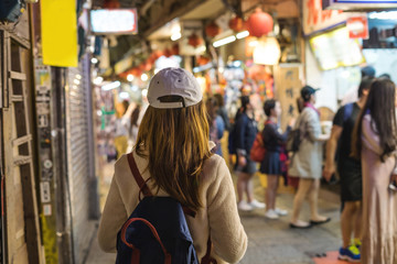 Young traveler walking at old street market at jiufen