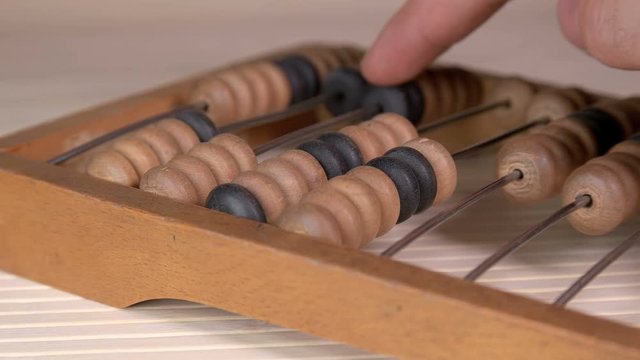 Man uses vintage old abacus