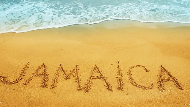 The inscription Jamaica on sand.