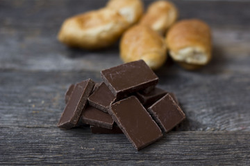croissants and chocolate pieces on a wooden table