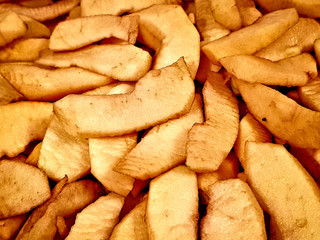 Fresh appetizing yellow apples are cut into pieces for baking
