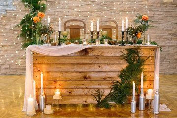interior, holidays, engagement concept. furniture made of natural materials, used for celebration of wedding in the restaurant, it is surved for couple of lover and decorated with plants and candles
