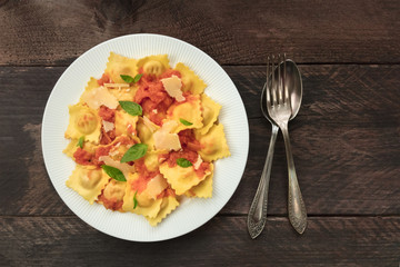 Plate of ravioli with tomato sauce and copy space