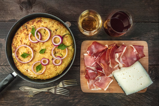 Spanish tortilla in tortillera, with wine, jamon, and cheese