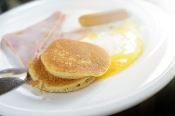 Fototapeta na wymiar Breakfast includes fried egg, ham sausage pancakes eatimg nutritious every morning