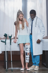 Doctor helping patient stand up