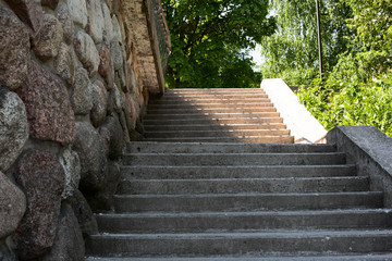Stone staircase with a cobblestone wall in a bright day