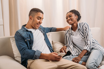 couple sitting with smartphones