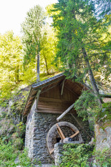 Old water mill in the forest thicket. Western Carinthia, Austria