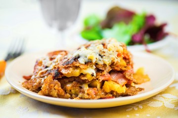 Pancake from buckwheat flour (galette) with apple, bacon, ham and cheese filling.