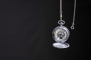 Fototapeta na wymiar Clock pocket on a dark background