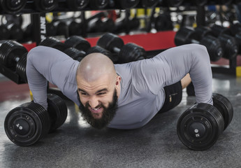 Fototapeta na wymiar Professional bodybuilder doing push-up exercise, sports training , lifestyle
