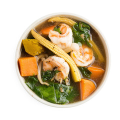 Spicy vegetable and prawn soup isolated on white background