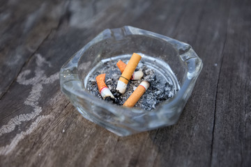 Smoking cigarettes is in the ashtray.