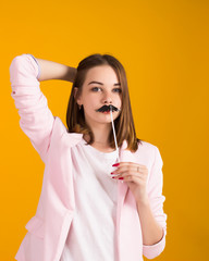 Young cute girl with moustache, studio  