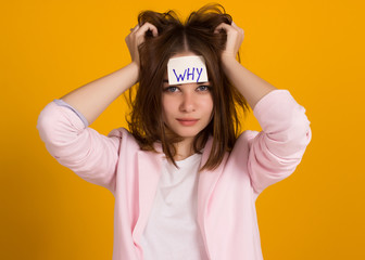 Young cute girl, sticker on a head, studio 