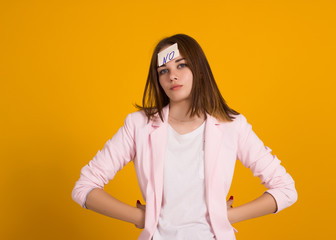 Obraz premium Young cute girl, sticker on a head, studio 
