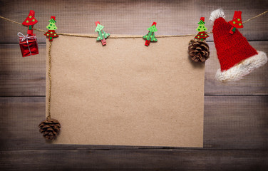Christmas background with copy space. Vintage sheet of paper hangs on clothespins with decorative...