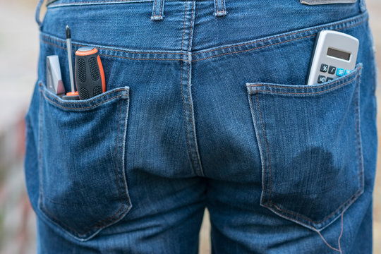 Calculator and screwdrivers in the back jeans pockets - Powered by Adobe