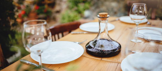 Wine decanter and glasses on dining table