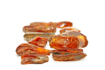 Amber red in perspective with a bokeh effect on a white background. Amber background and texture. Background for jewelry stores and advertising jewelry. Sunstone is a natural jewelry mineral. Red 