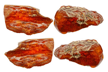 Four pieces of amber on a white background. Natural mineral, hardened ancient resin of red color. A collage of amber pieces. Sun stone as a background for advertising layouts. Amber background.