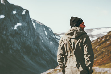 Man traveler hiking in mountains Travel lifestyle concept survival into the wild vacations