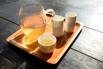 Hot tea cup on wooden table background in sunshine day