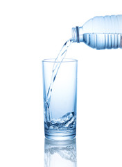 pouring water on a glass isolated on white background