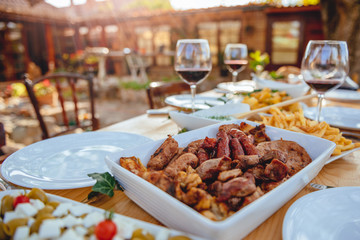 Served barbecue meat at dining table