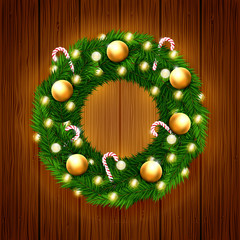 Vector Christmas wreath with candy canes, shiny Christmas lights and beautiful golden decorations on wood texture background