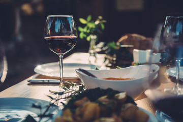 Obraz na płótnie Canvas Glass of wine at dining table