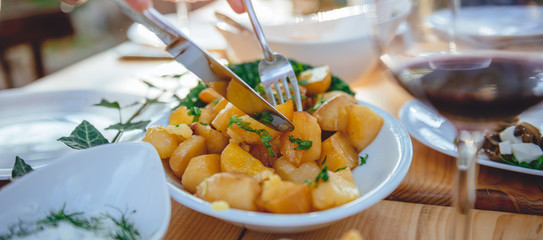 Woman serving roasted potato