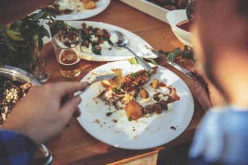 Men eating fish and ships