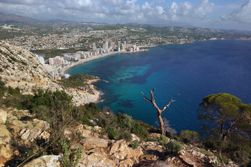 View from the mountain Ifach on a steep stony slope, the blue sea and coastal town of Kalp on the Mediterranean coast in Spain, the Costa Blanca region