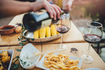 Close up photo of men pouring red wine