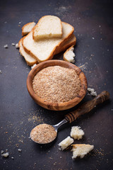 Bowl of breadcrumbs and slices of a loaf