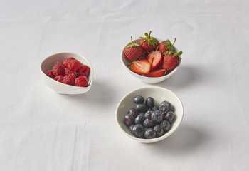 strawberry raspberry blueberry on the white table