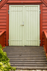 Big green oldfashioned wooden doors in house