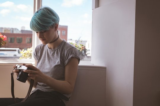 Woman using a camera at home