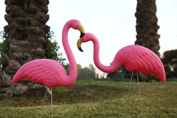 a pair of plastic flamingoes in the garden