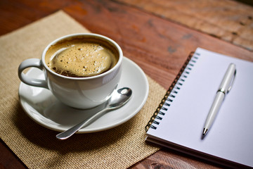Coffee cup hot and smartphone notebook pen