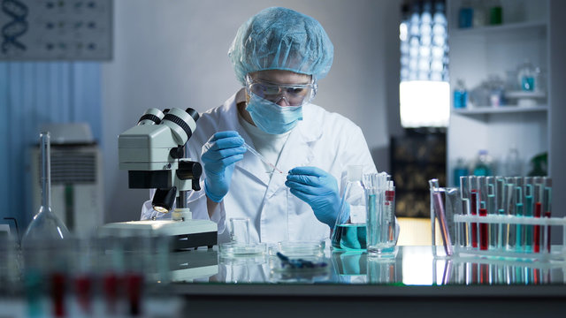 Lab Worker Dripping Sample Onto Laboratory Glass To Research Cloning Process