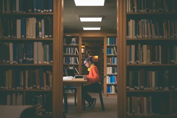 Girl reading book in library