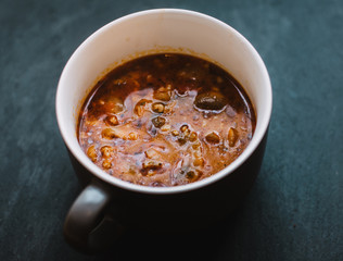 Pizza soup with meat, mushrooms, cheese, tomato and herbs