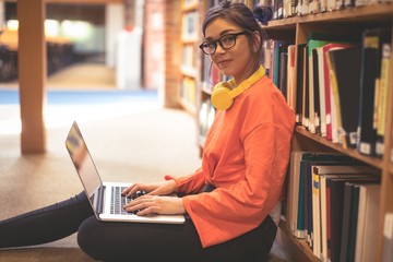 Portrait of confident girl using laptop