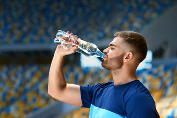 Drink Water From Bottle. Man Drinking After Running.