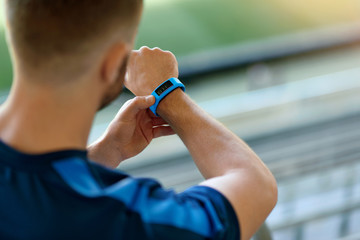 Close Up Of Man Using Smart Watch On Street.