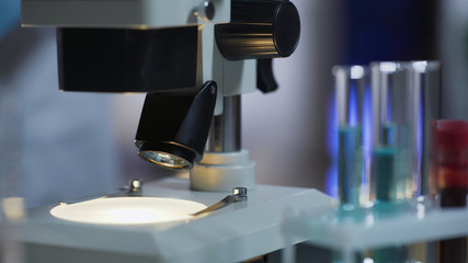 Closeup of clean working surface of microscope ready for medical test, equipment