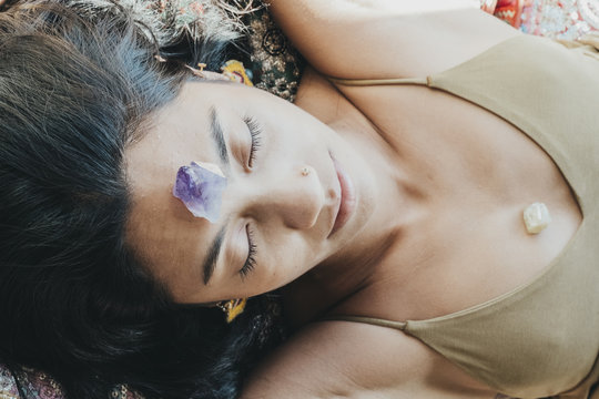 Woman laying down with crystals